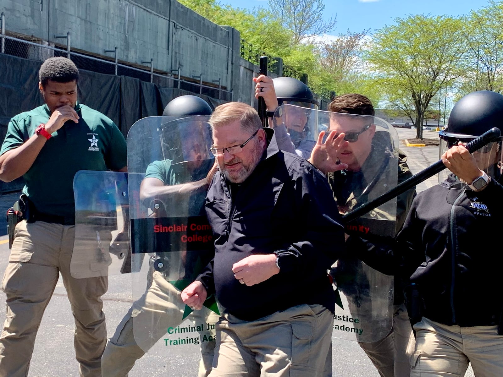 Jeff Thomas, former Sinclair Police Academy commander and Dayton police lieutenant, attempts to break through a line of cadets during civil unrest training. LONDON BISHOP/STAFF